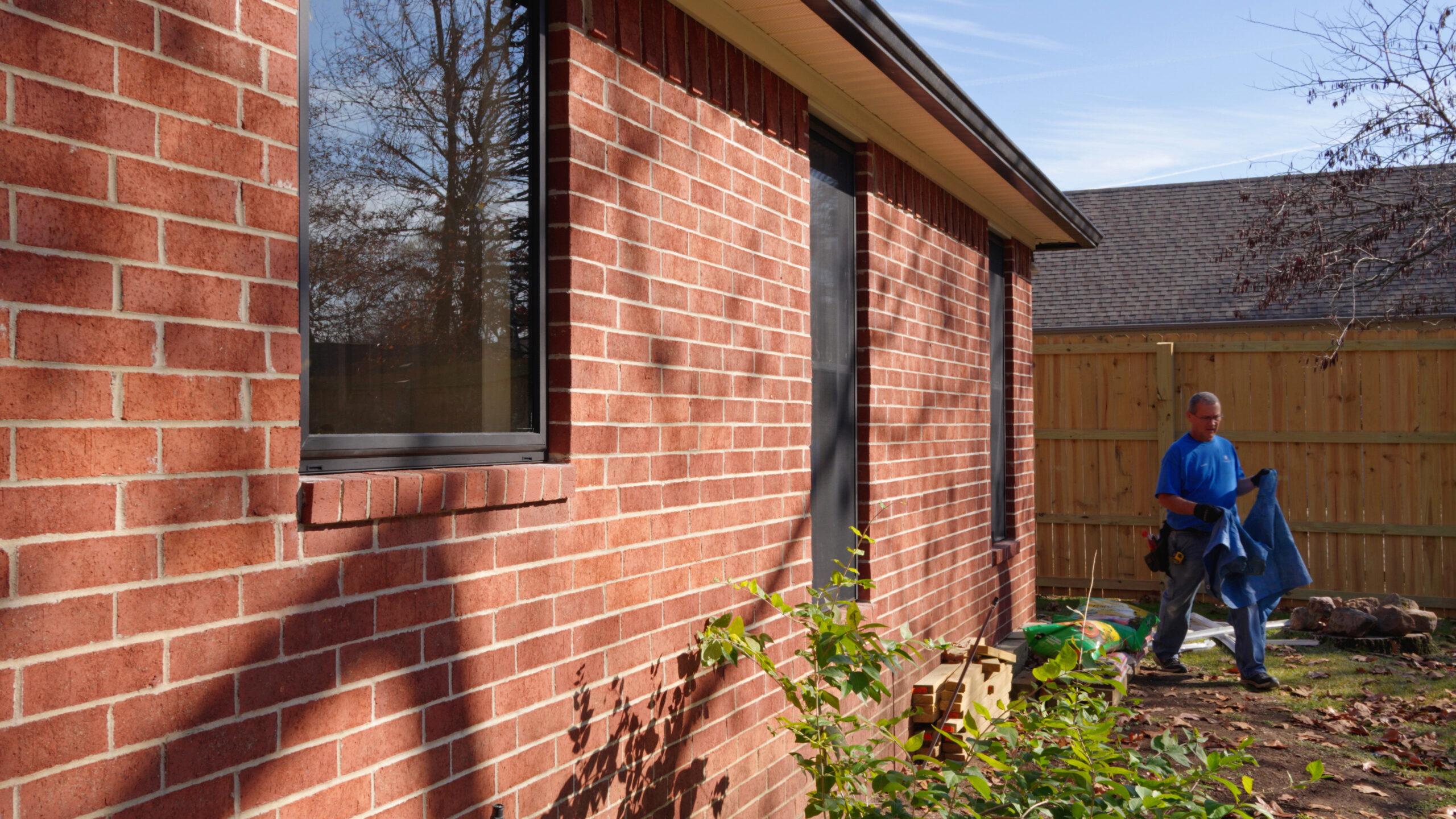 Professional Window Replacement - A newly installed window enhances this brick home's energy efficiency, security, and aesthetic appeal.