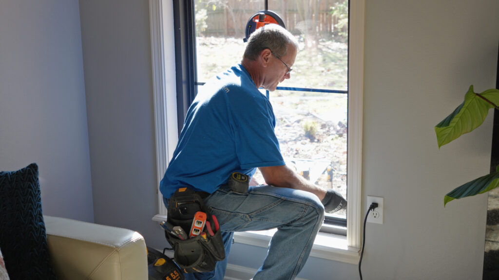 Interior view of a technician completing a window replacement service in Central Arkansas.